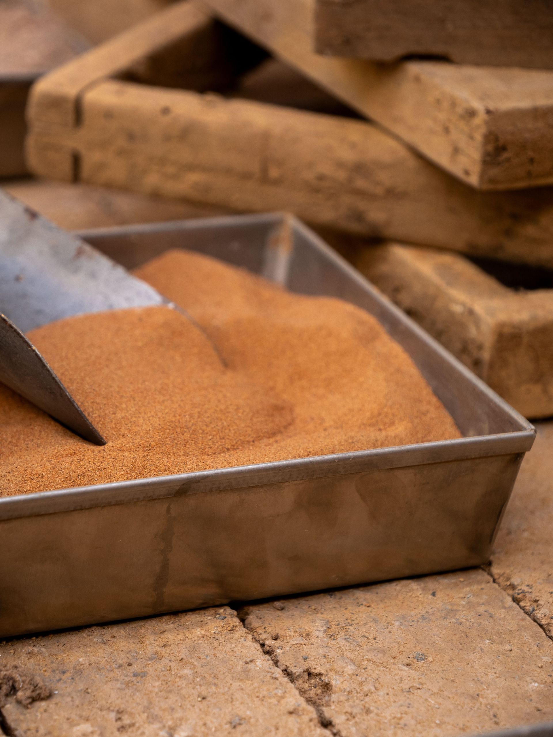 Detailed shot of fine sand in a metal tray used for bricklaying or construction work.